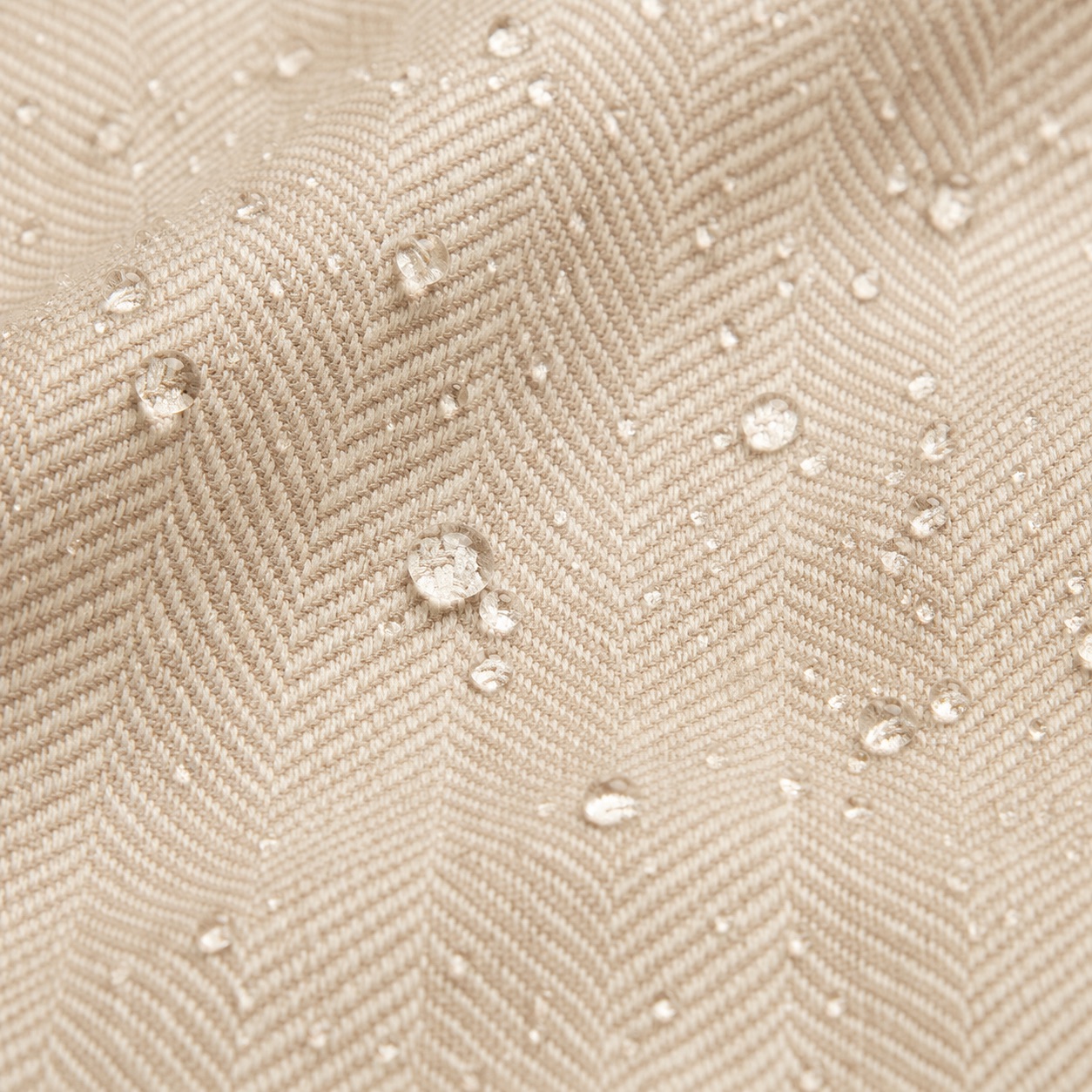 Cream waterproof herringbone tweed with water droplets